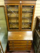 A SHERATON STYLE EDWARDIAN MAHOGANY BOOKCASE BUREAU with swan neck pediment, twin thirteen pane