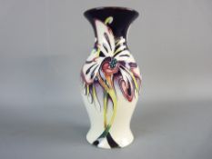 A MOORCROFT MODERN PATTERNED BALUSTER VASE with stylized floral decoration on a purple and cream