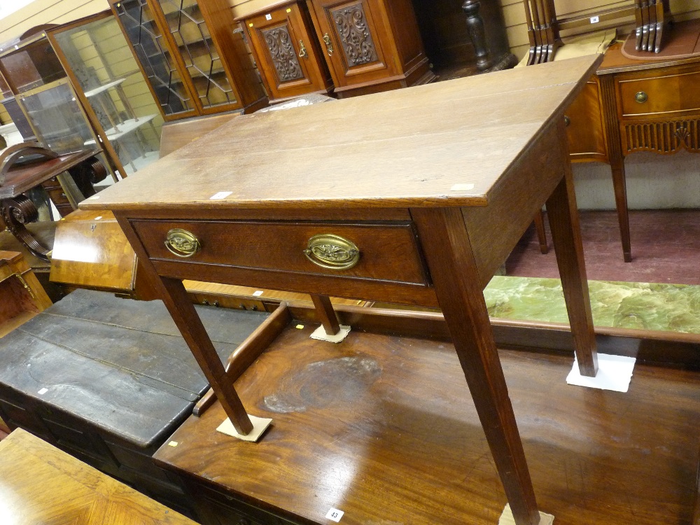 AN ANTIQUE OAK SINGLE DRAWER SIDE TABLE, the three plank top over a cock beaded edge drawer, pine