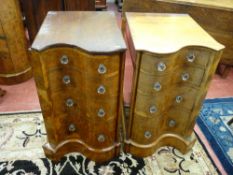 A PAIR OF OAK AND WALNUT SERPENTINE FRONT BEDSIDE CHESTS of four drawers with glass knobs, 73.5