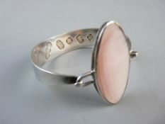 A MODERN SILVER BANGLE with mother of pearl oval top, oversized hallmarked for Sheffield 2004, 1.2