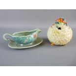 A CLARICE CLIFF POTTERY SAUCE BOAT AND TRAY having a floral and basket weave pattern in relief,