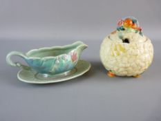 A CLARICE CLIFF POTTERY SAUCE BOAT AND TRAY having a floral and basket weave pattern in relief,