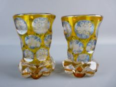 A PAIR OF LATE 19th CENTURY BOHEMIAN GLASS VASES, amber to clear with continuous bands of faceted