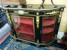 A VICTORIAN EBONIZED CREDENZA with gilt metal mounts, the shaped top over a gilt metal cartouche