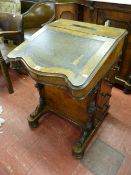 A 19th CENTURY INLAID WALNUT DAVENPORT having a shaped tooled leather skiver to the sloping top,