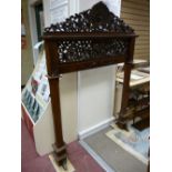 AN ORIENTAL STYLE CARVED HARDWOOD SURROUND, the pierced top rail with central phoenix flanked by