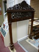 AN ORIENTAL STYLE CARVED HARDWOOD SURROUND, the pierced top rail with central phoenix flanked by