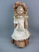 AN ANTIQUE BISQUE HEADED DOLL with jointed leather body having blonde hair and blue eyes, open