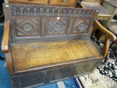 AN 18th CENTURY AND LATER BOX SEAT HALL BENCH with carved panel back, lidded seat and plain front,