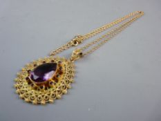 A GOLD FINE LINK CHAIN with a heart shaped filigree pendant having a large purple stone, 3.3 grms (