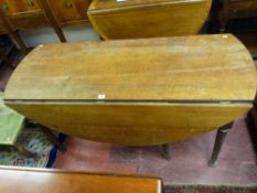 AN EARLY OAK TWIN FLAP DINING TABLE on six turned and block supports, the central two knuckle