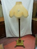 A QUALITY VINTAGE BRASS STANDARD LAMP AND SHADE, the stepped base with applied paw feet and plinth