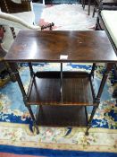 A VICTORIAN MAHOGANY THREE TIER SIDE TABLE AND BOOKSTAND with turned and block pillar supports on