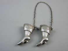 A PAIR OF SILVER KNITTING NEEDLE TIP RESTS in the form of lady's boots, 0.15 troy oz
