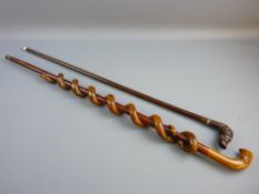 A VINTAGE HARDWOOD WALKING CANE with carved dog's head handle, having inset eyes and a white metal