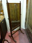 A REGENCY MAHOGANY CHEVAL MIRROR, rectangular with cushion veneer and turned finials on reeded
