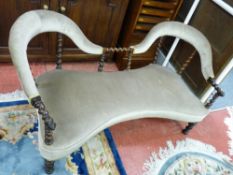 A VICTORIAN TWO SEATER SALON SETTEE, upholstered double back with barley twist support and central