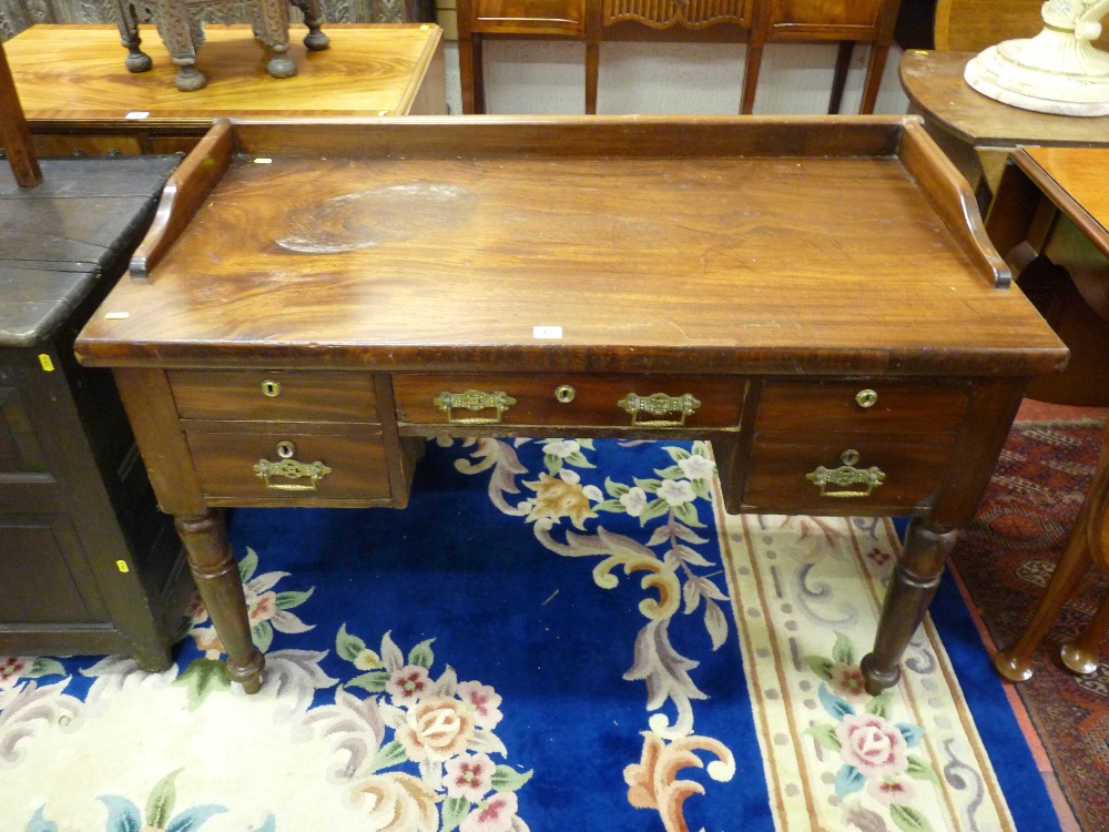 A LATE 19th/EARLY 20th CENTURY MAHOGANY DESK with railback and sides over an arrangement of four