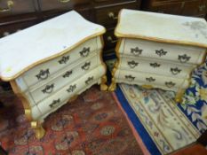 A PAIR OF FRENCH STYLE BOMBE CHESTS having a shaped gilded edge top and three front drawers with