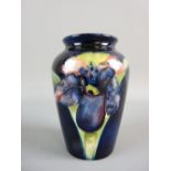 A MOORCROFT ORCHID VASE, 10 cms high, decorated on a cobalt blue ground, impressed marks to the base