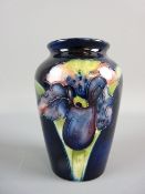 A MOORCROFT ORCHID VASE, 10 cms high, decorated on a cobalt blue ground, impressed marks to the base