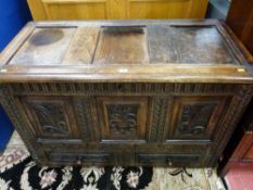 A 19th CENTURY OAK MULE CHEST, the triple panel hinged top over a carved frieze and border