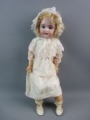 A SIMON & HALBIG BISQUE HEADED DOLL with sleep/open blue eyes, open mouths with teeth and painted