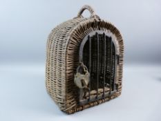 A VINTAGE WICKER PET CARRIER with iron door, Alcyon padlock and key, 33 cms high