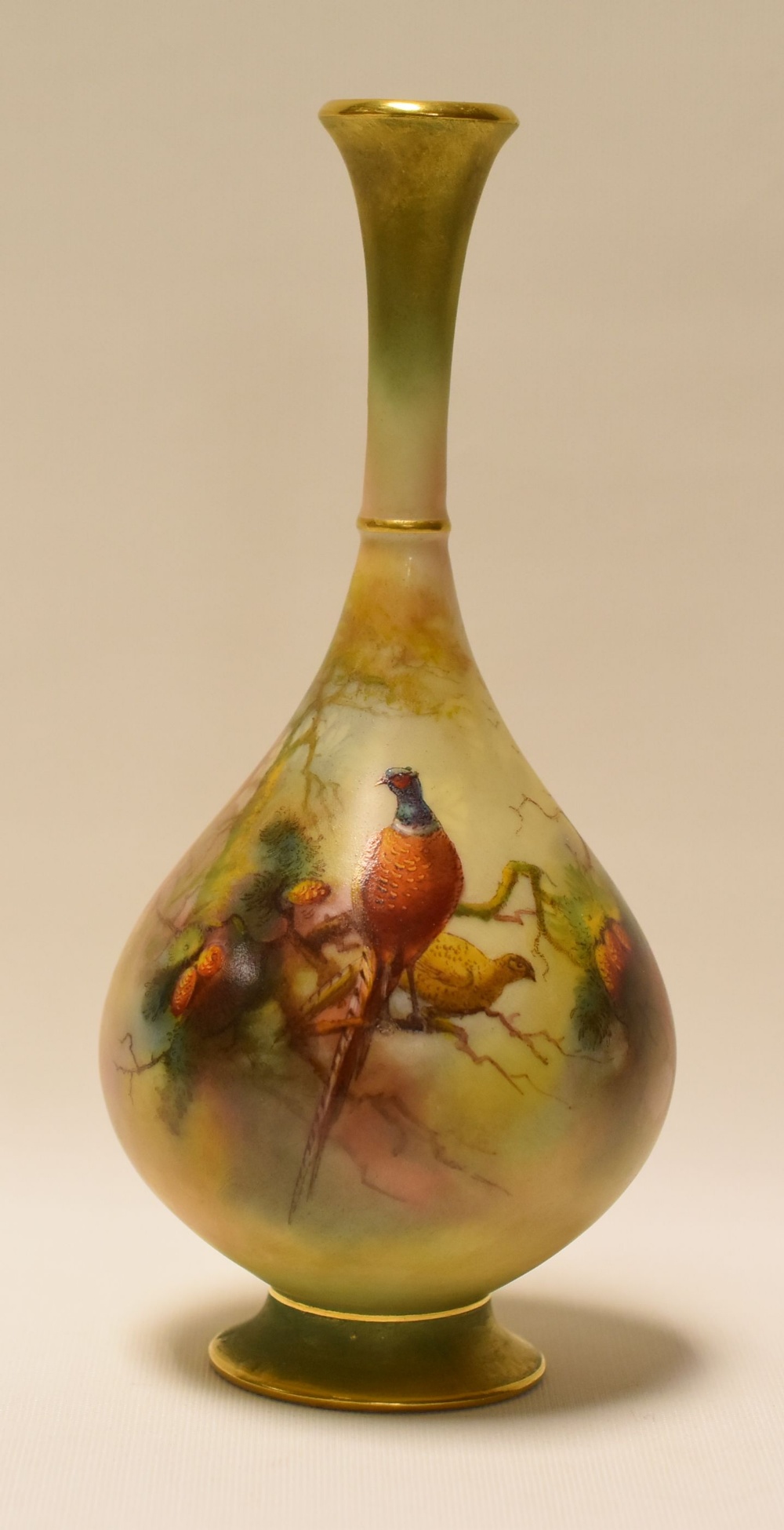 A ROYAL WORCESTER NARROW NECKED VASE painted with pheasants perched in fir trees by Walter