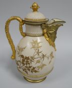 A ROYAL WORCESTER BLUSH LIDDED JUG having a mask head spout, faux bamboo handle and basket weave