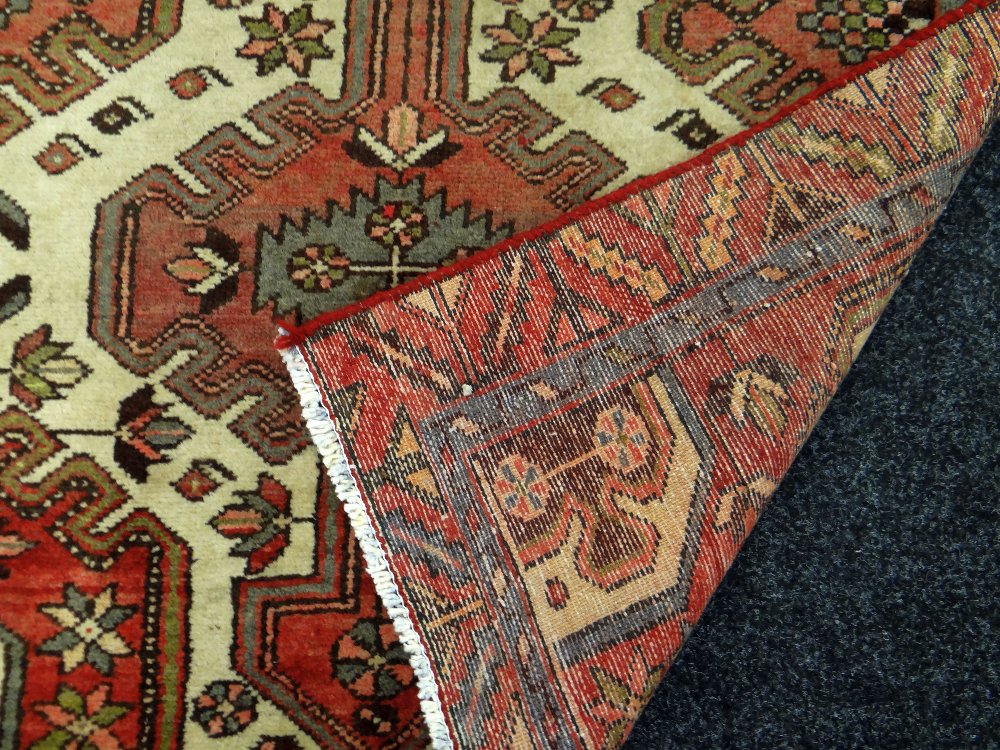 A WASHED RED GROUND PERSIAN RUNNER MEDALLION DESIGN, 290 x 110cms - Image 3 of 3