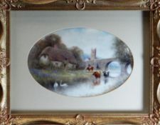 FRAMED OVAL ROYAL WORCESTER PLAQUE of concave form, painted with a thatched cottage, church, bridge,