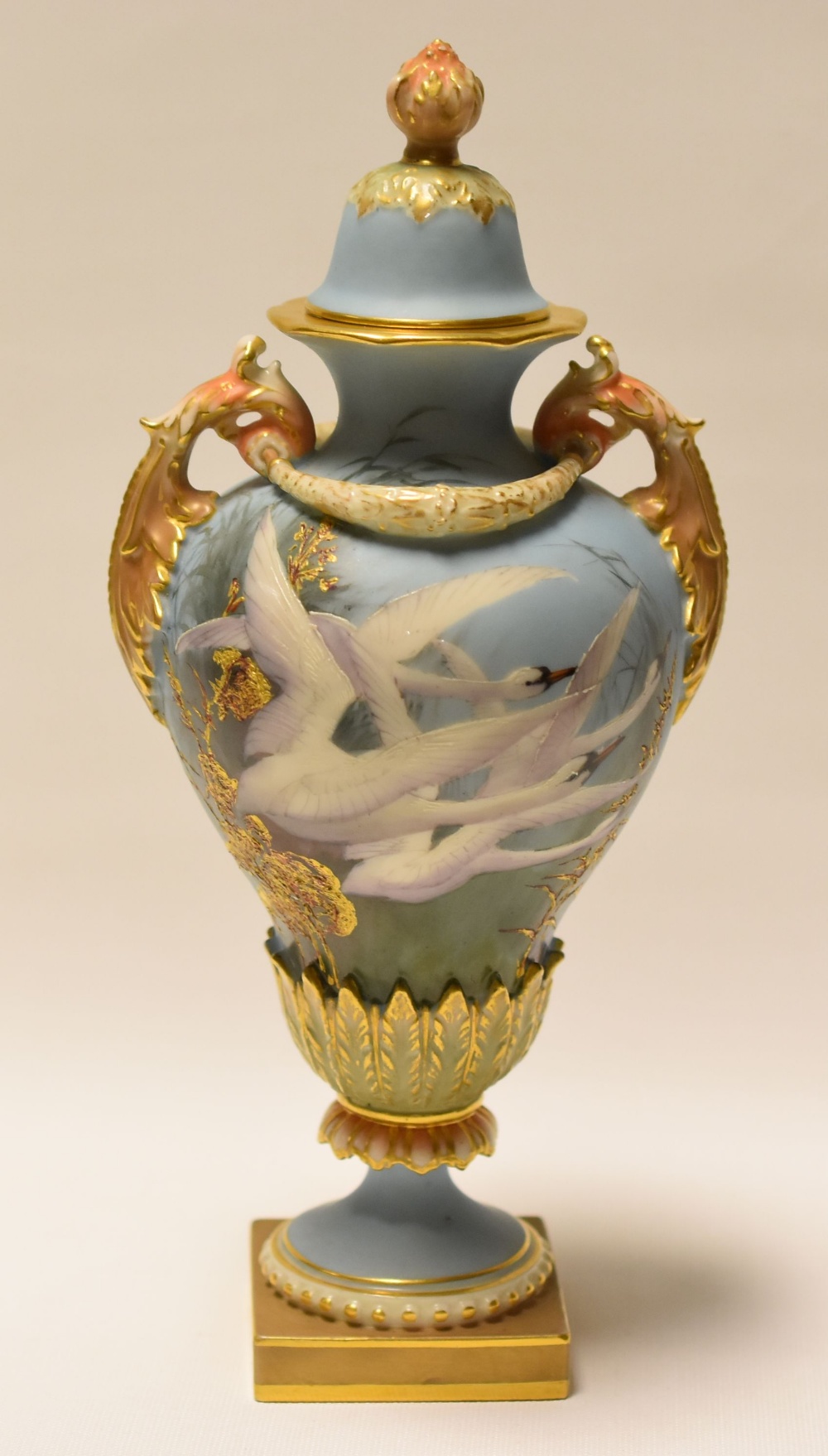 A ROYAL WORCESTER VASE DECORATED BY CHARLES BALDWYN with cover and painted with four swans in flight