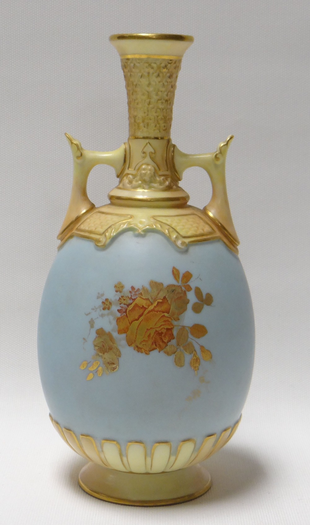 A ROYAL WORCESTER POWDER BLUE TWIN-HANDLED VASE decorated with gilded flowers and with yellow glazed - Image 2 of 2