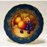 A ROYAL WORCESTER PLATE DECORATED WITH FRUIT BY RICHARD SEBRIGHT with mottled peacock-blue reserve