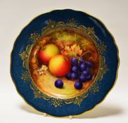 A ROYAL WORCESTER PLATE DECORATED WITH FRUIT BY RICHARD SEBRIGHT with mottled peacock-blue reserve