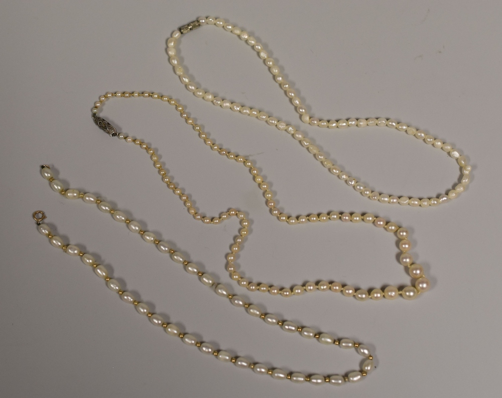 A SINGLE ROW OF GRADUATED PEARLS & A NECKLACE OF OVAL PEARLS and another