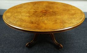 A VICTORIAN OVAL WALNUT BREAKFAST TABLE with tilt-top mechanism on four scroll supports, 58cms long