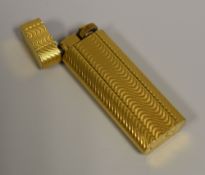 A CARTIER PARIS GOLD-PLATED LADIES CIGARETTE LIGHTER with guilloche style decoration (working)