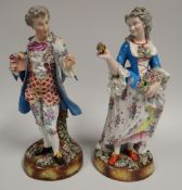 A PAIR OF CONTINENTAL PORCELAIN FLOWER PICKERS in floral and brightly painted costumes upon floral