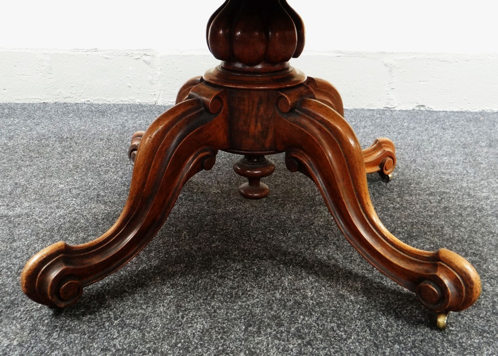 A VICTORIAN OVAL WALNUT BREAKFAST TABLE with tilt-top mechanism on four scroll supports, 58cms long - Image 3 of 3