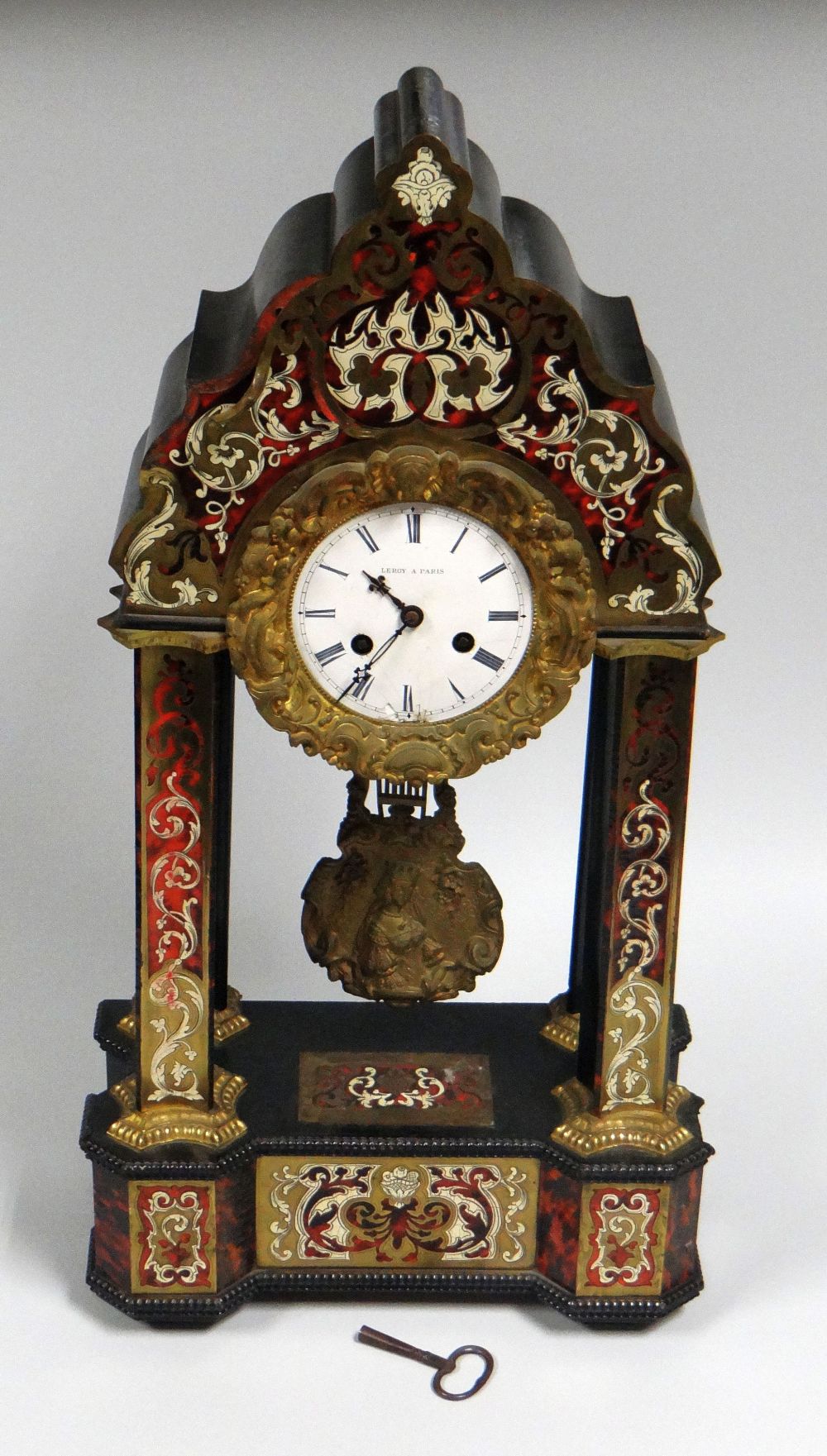 A FRENCH TORTOISE SHELL & ORMOLU MANTEL CLOCK of architectural form with white enamel dial bearing