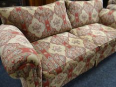 A MODERN THREE SEATER FLORAL SETTEE