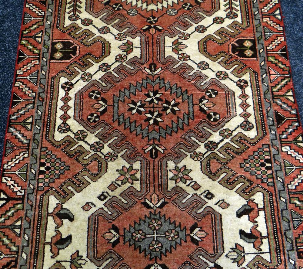 A WASHED RED GROUND PERSIAN RUNNER MEDALLION DESIGN, 290 x 110cms - Image 2 of 3