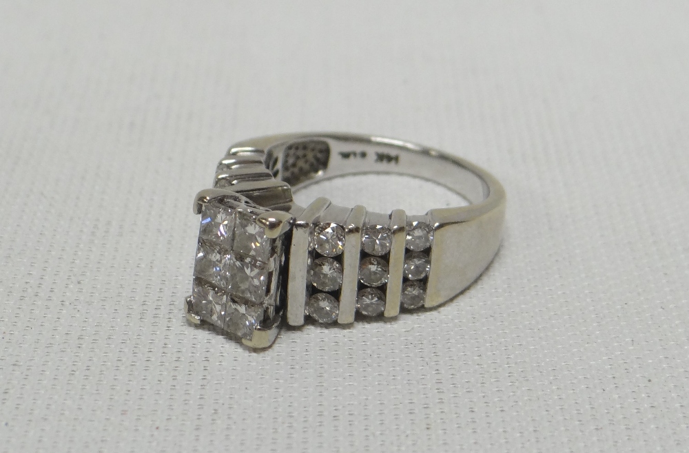 A 14K WHITE GOLD DIAMOND CLUSTER RING with a platform of six diamonds raised above nine diamonds