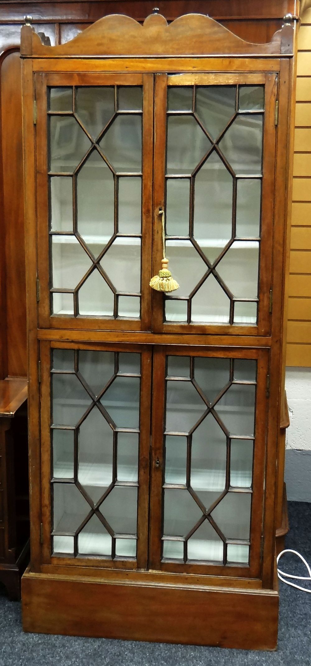 A TWO-STAGE OAK STANDING DISPLAY CABINET composed of four astragal glazed doors, 189cms high