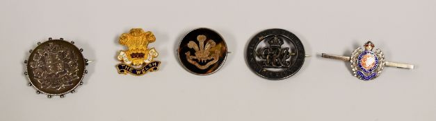 FIVE MILITARY PINS includes a silver and tortoise-shell Welch Regiment example and two enamelled