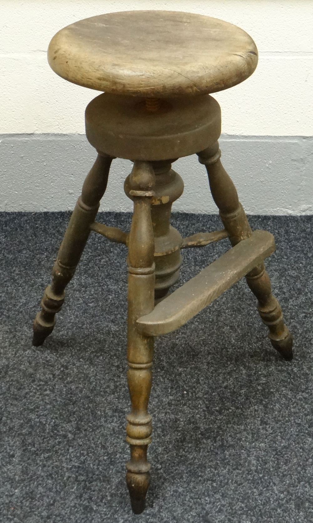 AN EARLY TWENTIETH CENTURY INDUSTRIAL MACHINISTS STOOL the circular seat revolving above three