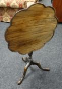 A TILT-TOP TRIPOD TABLE the top of lobed galleried form, 65cms diam